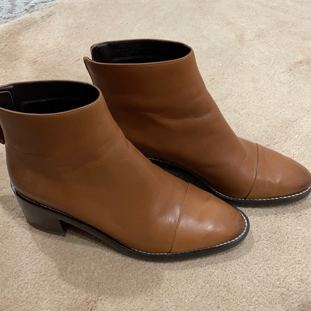 Tan waterproof bootie with 1 1/2" chunky heel and zipper in back.